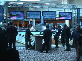The hotel atrium was the central traffic area between the entrance and the presentation rooms. Plasma displays ran a Director-based application with a Tech 2000 theme animation and real-time updating information such as the current presentations, schedule